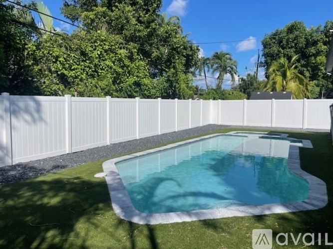 A small pool surrounded by a white fence.