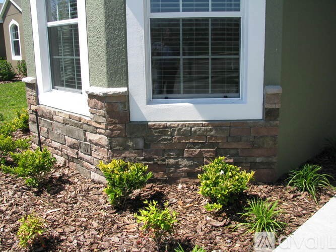A house with a window and a stone wall.