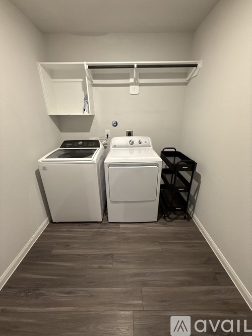 A small laundry room with a washer and dryer.