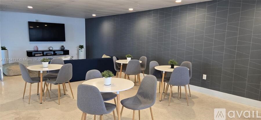 A room with a black wall and a TV mounted on it.