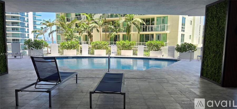 A patio with a pool and chairs is available for rent.