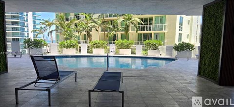 A patio with a pool and chairs is available for rent.