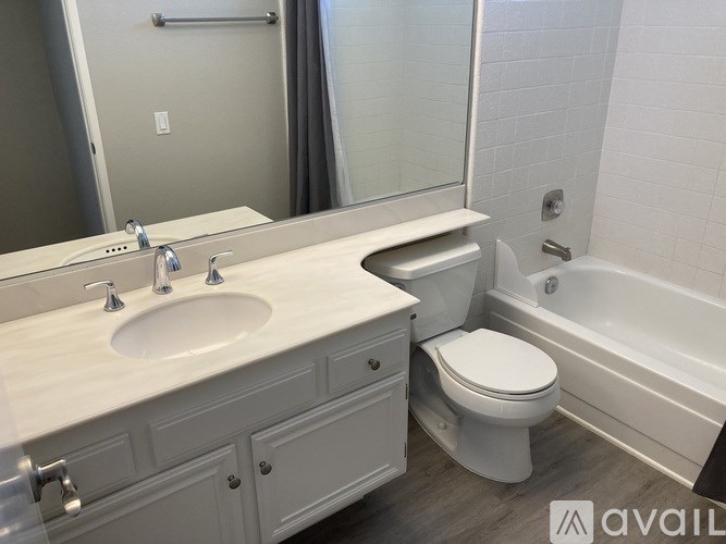 A white bathroom with a sink, toilet, and bathtub.