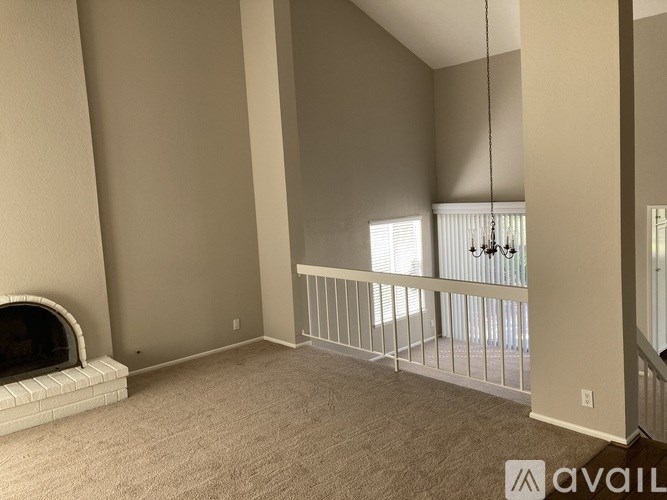 A living room with a fireplace and a balcony.