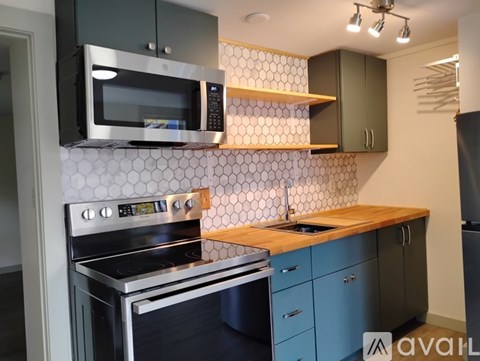A kitchen with a stove top oven and microwave above it.
