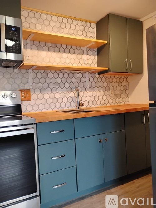 A kitchen with a stove top oven and a microwave.