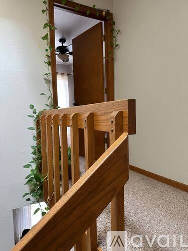 A wooden staircase with a mirror on the wall.
