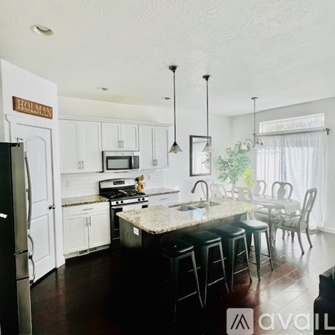A kitchen with white cabinets and a granite countertop.