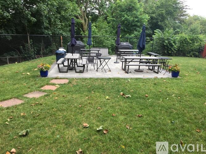 A backyard with a picnic table and chairs.