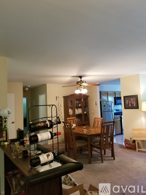 A kitchen with a dining table and chairs.