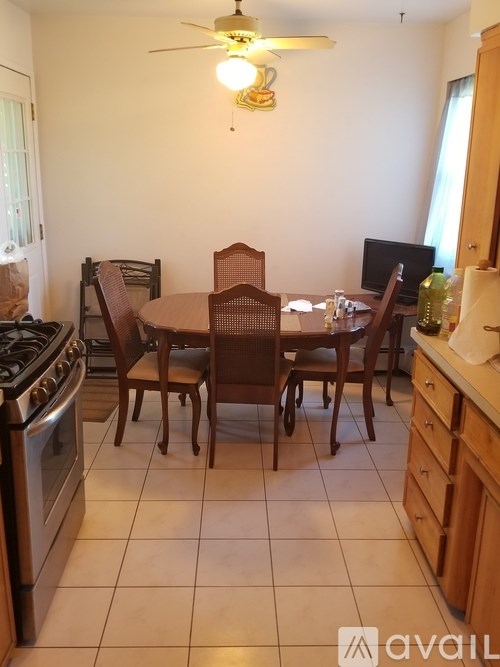 A kitchen with a table and chairs in the middle of the room.