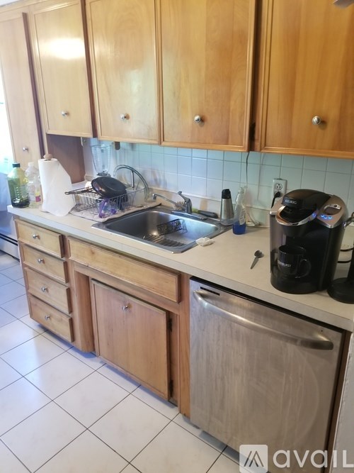 A kitchen with wooden cabinets and a white countertop.