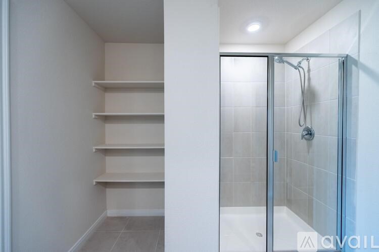 A white bathroom with a walk in shower.