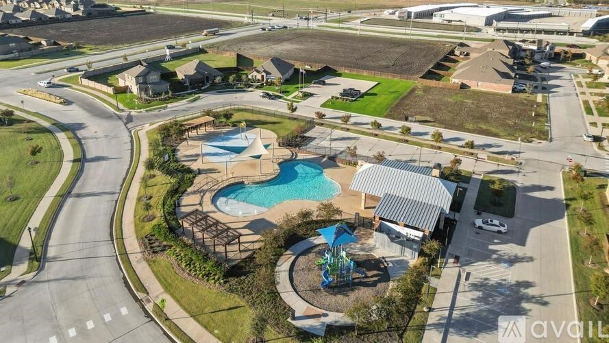 An aerial view of a community with a swimming pool and a playground.