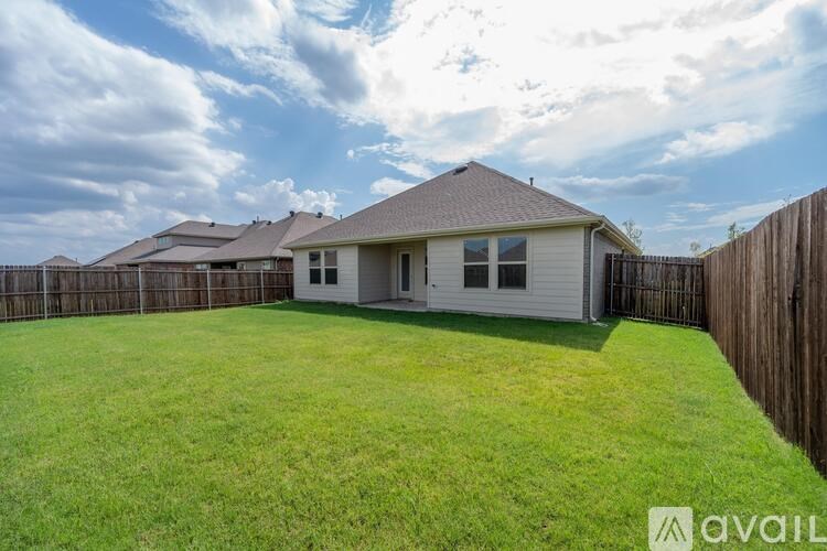 A house with a fence and a grassy yard is available for sale.