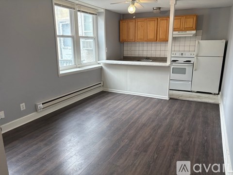 A kitchen with wooden cabinets and a white refrigerator.
