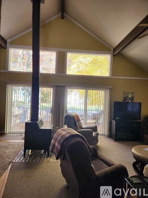 A living room with a couch and a television.