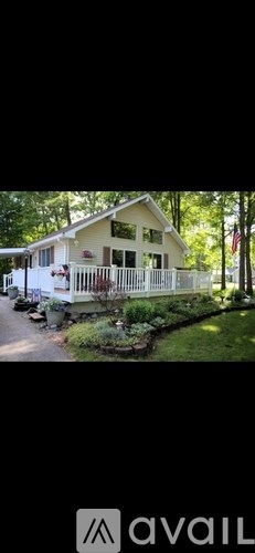 A house with a white fence and a flag on the front porch.