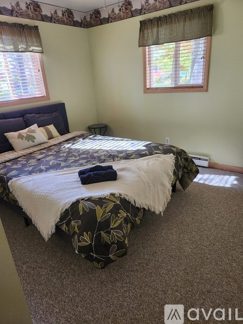 A bedroom with a bed and a window.
