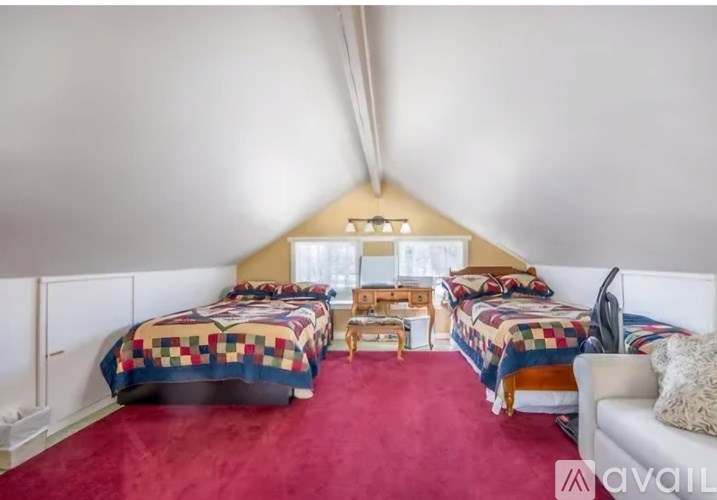 A room with two beds and a couch.