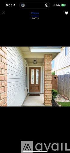 A brown door is on a white house.