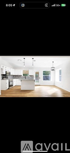 A modern kitchen with white cabinets and a large island.