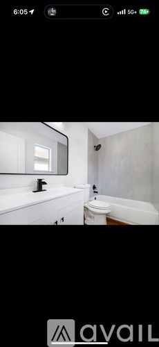 A bathroom with a white tub and sink.
