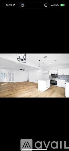 A room with wooden flooring and white walls.
