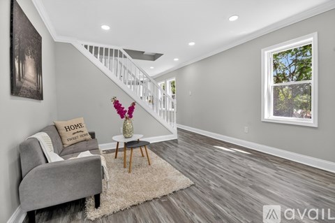 A living room with a grey couch and a wooden table.