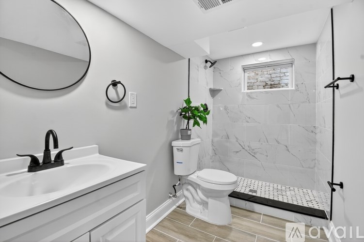 A bathroom with a white sink and toilet.