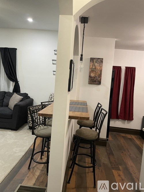 A dining area with a table and chairs.