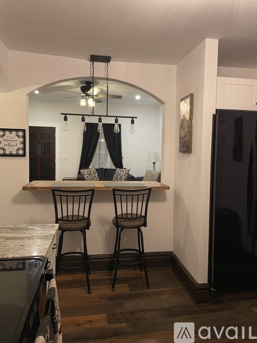 Two chairs are placed in front of a bar.