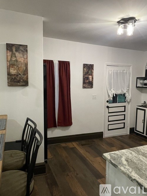 A room with a chair and a table with a marble top.