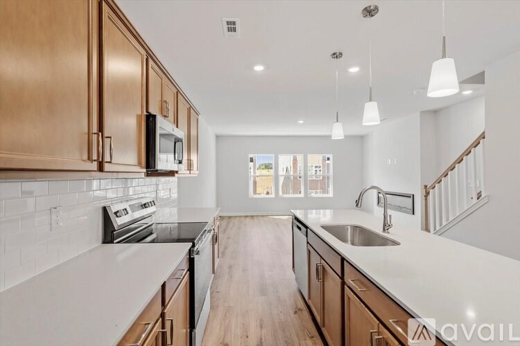 A kitchen with wooden cabinets and a white countertop.