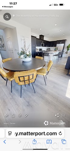 A modern kitchen with a round dining table and chairs.