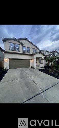 A house with a large driveway and a garage.