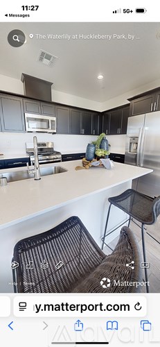 A kitchen with a sink and a chair.