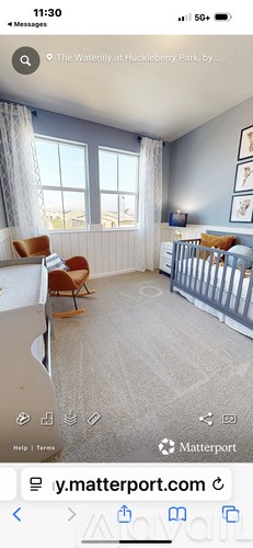 A baby's room with a crib and a chair.
