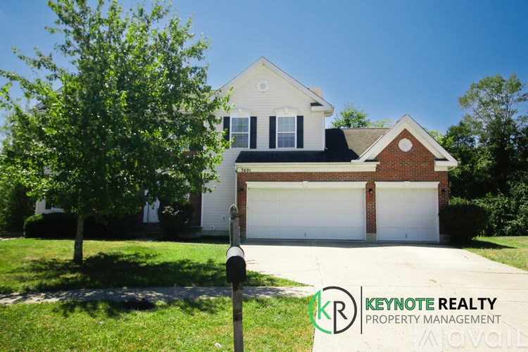 A house with a tree in front of it and a sign that says Keynote Realty Property Management.