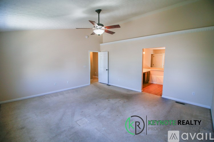 A room with a ceiling fan and a Keynote Realty logo.