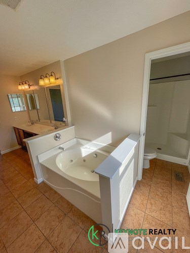 A bathroom with a bathtub, toilet, and sink.