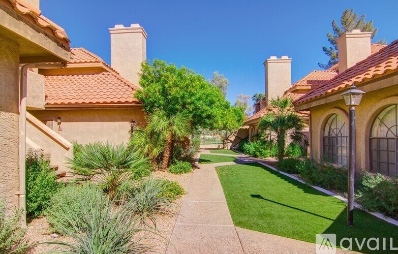 A sunny day in a quiet residential area with houses and greenery.