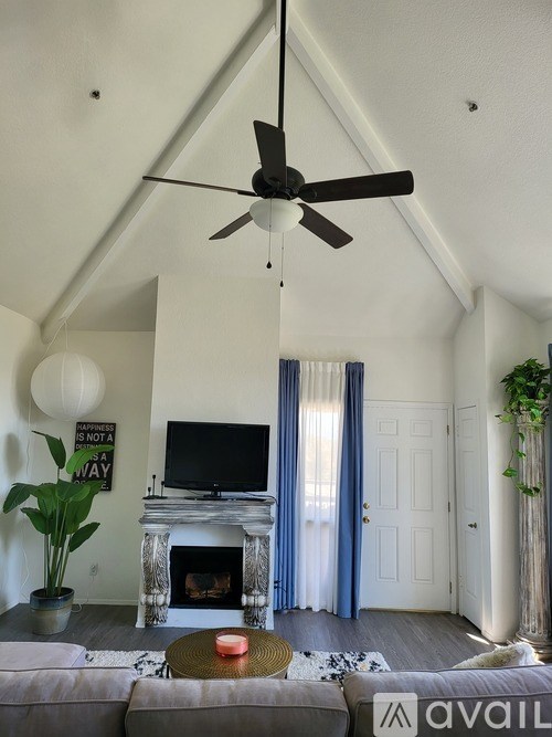 A living room with a fireplace and a television.