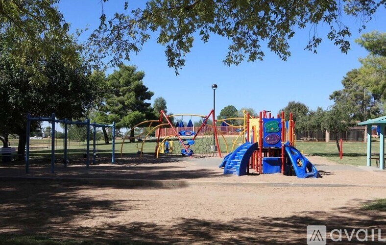A playground with a blue slide and a red and yellow structure.