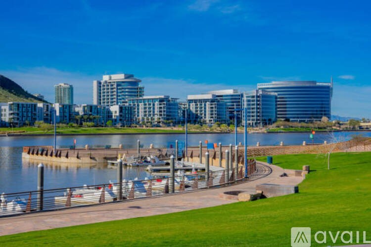 A cityscape with a body of water in the foreground and buildings in the background.