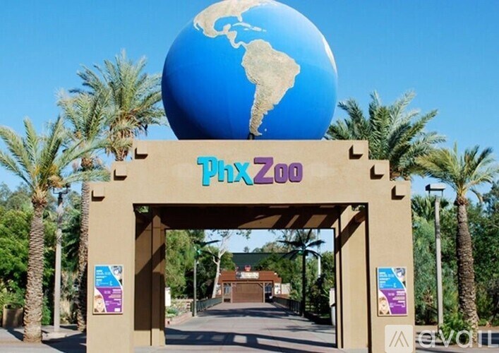The entrance to the Phoenix Zoo with a large globe above the name.