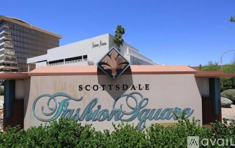 A sign for Scottsdale Fashion Square is displayed in front of a building.