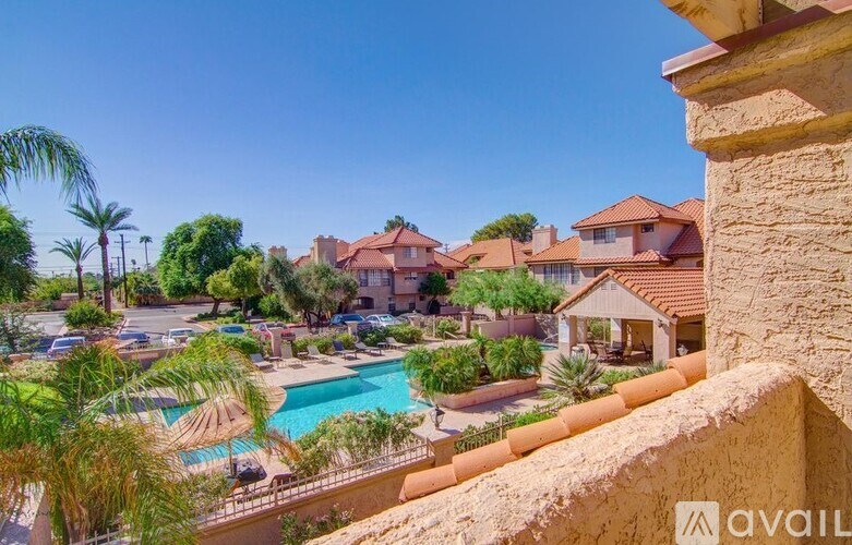 A view of a pool and a house from a balcony.