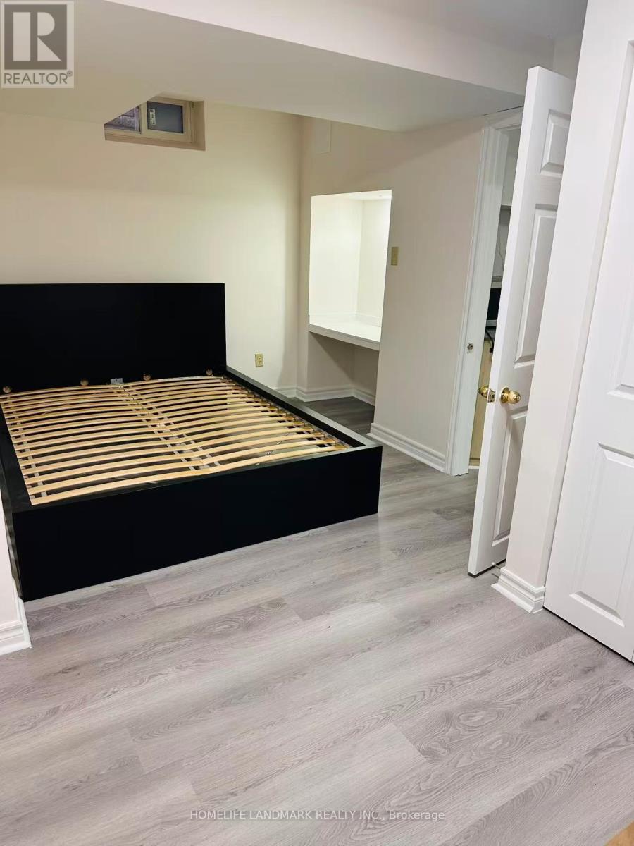 A bedroom with a black bed and a white door.