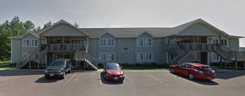 A large building with a parking lot in front of it.